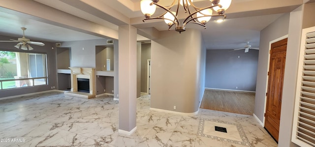 unfurnished living room with marble finish floor, baseboards, a ceiling fan, and a glass covered fireplace