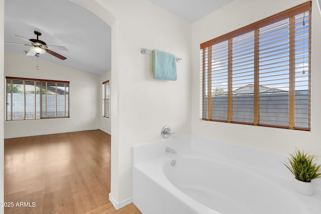 30215 N Joshua Tree Dr, Florence, AZ 85132 - bathroom with a ceiling fan, a garden tub, lofted ceiling, and wood finished floors
