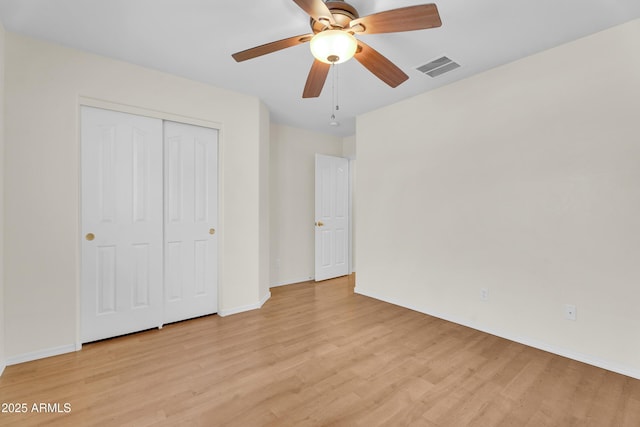 30215 N Joshua Tree Dr, Florence, AZ 85132 - unfurnished bedroom featuring light wood finished floors, a closet, and a ceiling fan