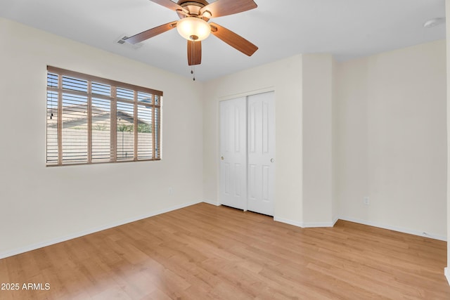 30215 N Joshua Tree Dr, Florence, AZ 85132 - unfurnished bedroom with light wood finished floors, a closet, and a ceiling fan