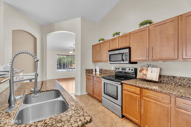 30215 N Joshua Tree Dr, Florence, AZ 85132 - kitchen featuring stainless steel appliances, stone countertops, light tile patterned flooring, and lofted ceiling