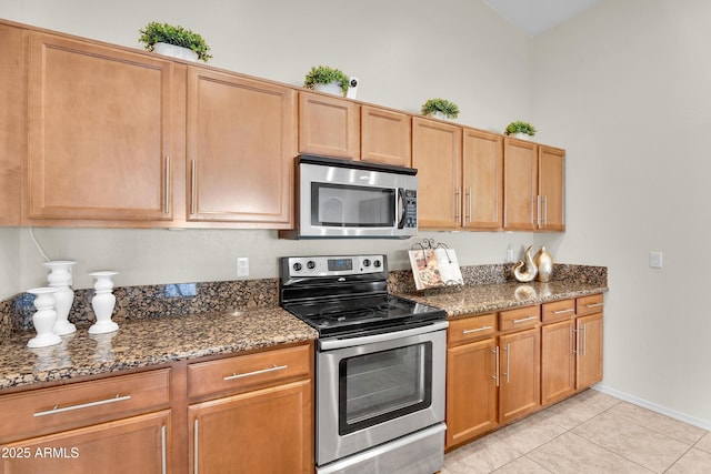 30215 N Joshua Tree Dr, Florence, AZ 85132 - kitchen with appliances with stainless steel finishes, dark stone counters, and light tile patterned flooring