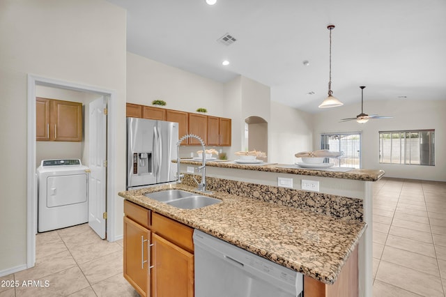 30215 N Joshua Tree Dr, Florence, AZ 85132 - kitchen featuring washer / clothes dryer, white dishwasher, stainless steel fridge with ice dispenser, light tile patterned floors, and lofted ceiling