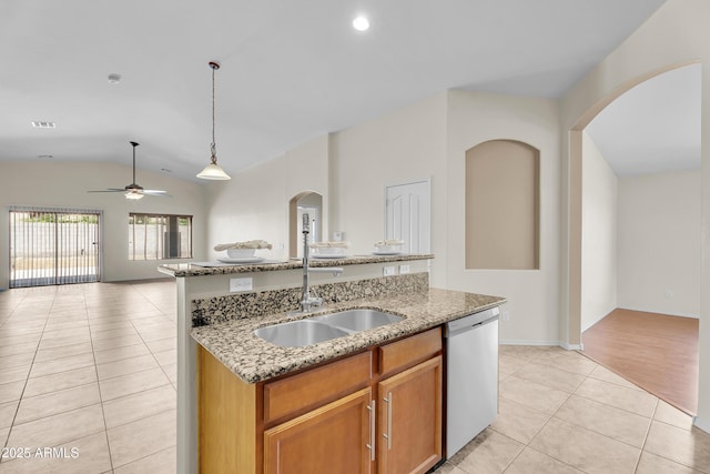 30215 N Joshua Tree Dr, Florence, AZ 85132 - kitchen featuring dishwasher, light tile patterned flooring, open floor plan, arched walkways, and lofted ceiling