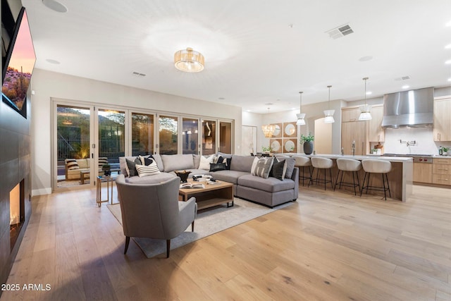 living room with french doors and light hardwood / wood-style floors