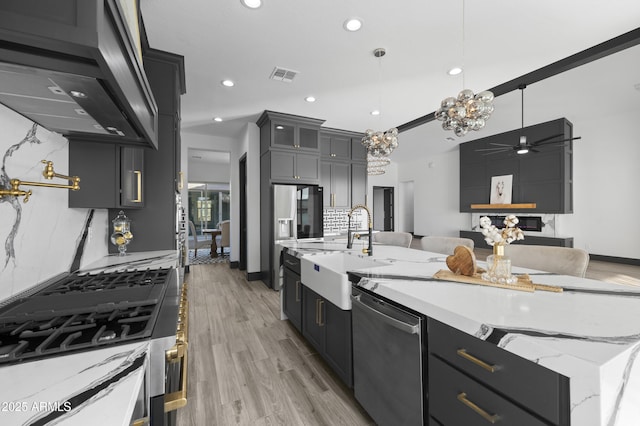 kitchen featuring stainless steel dishwasher, decorative backsplash, visible vents, and a sink