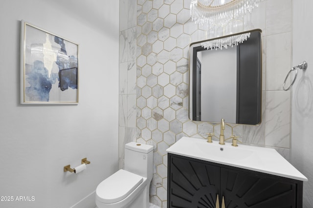 bathroom featuring vanity, tile walls, and toilet