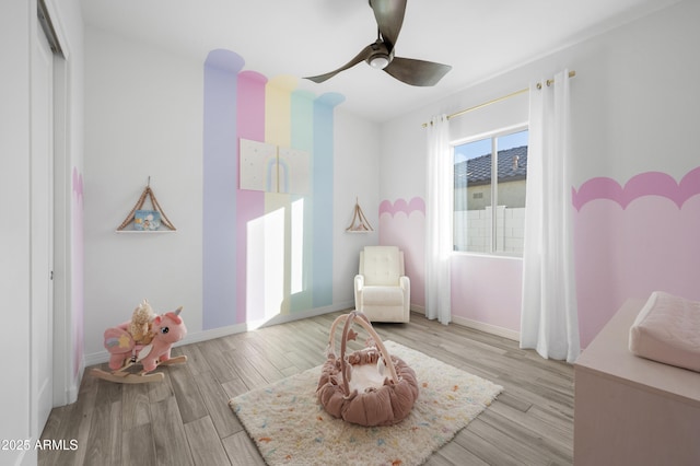 bedroom with ceiling fan, baseboards, and wood finished floors