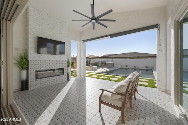 view of patio / terrace featuring a fenced backyard, a pool with connected hot tub, and ceiling fan