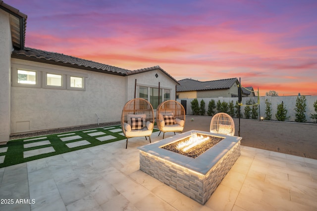 view of patio / terrace with a fire pit and fence