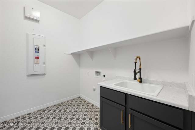 laundry area featuring baseboards, hookup for an electric dryer, cabinet space, a sink, and washer hookup