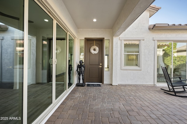 doorway to property with stucco siding