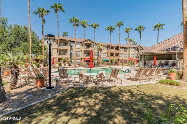 view of swimming pool with a lawn and a patio area