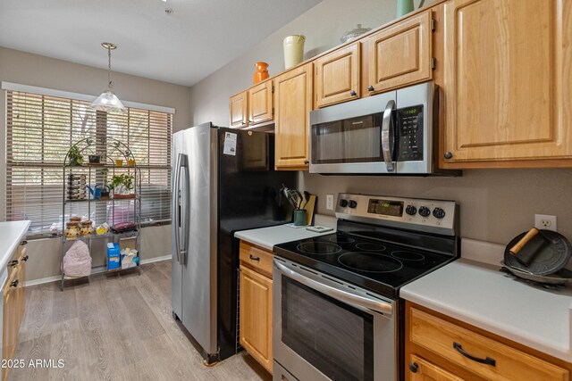 kitchen featuring dishwasher, sink, light hardwood / wood-style flooring, light brown cabinets, and decorative light fixtures