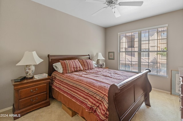 bedroom featuring light carpet, ceiling fan, and baseboards