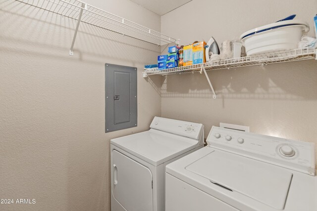 washroom with electric panel and separate washer and dryer