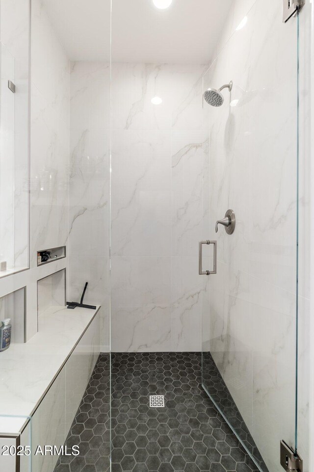 full bathroom with a marble finish shower