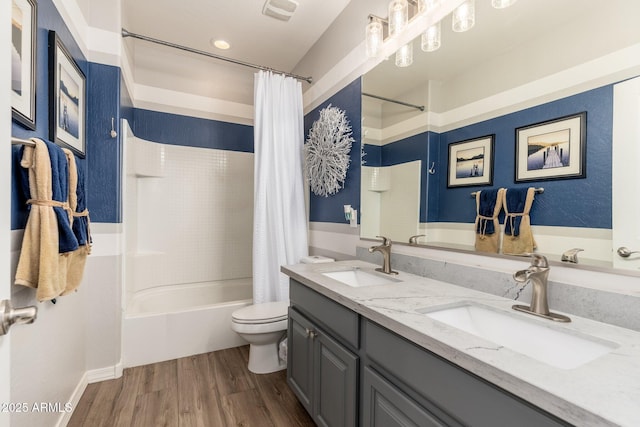 full bathroom with a sink, shower / bathtub combination with curtain, toilet, and wood finished floors