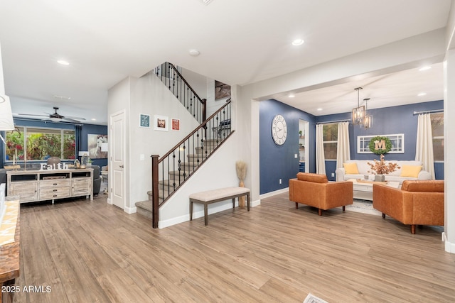 living area with recessed lighting, stairway, and light wood-style floors