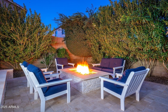 view of patio / terrace with an outdoor fire pit and fence