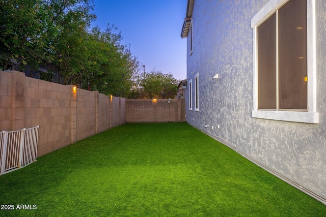 view of yard with a fenced backyard