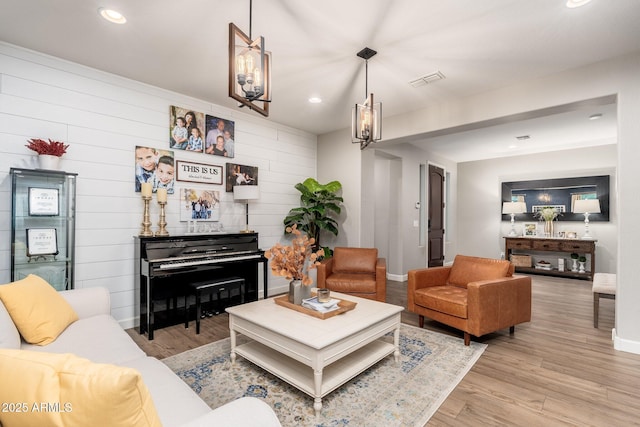 living room featuring light wood-style flooring, recessed lighting, and baseboards