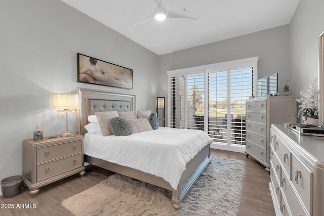 bedroom with ceiling fan, access to outside, and wood finished floors