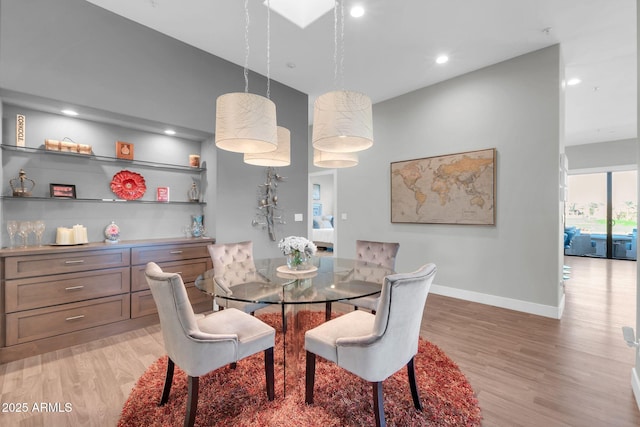 dining room featuring light wood-style floors, baseboards, and recessed lighting