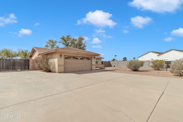 15210 S Country Club Way, Arizona City, AZ 85123 - view of side of property with fence, a tiled roof, concrete driveway, stucco siding, and a garage