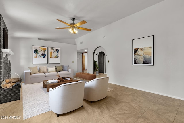 15210 S Country Club Way, Arizona City, AZ 85123 - living area with lofted ceiling, arched walkways, a fireplace, baseboards, and ceiling fan