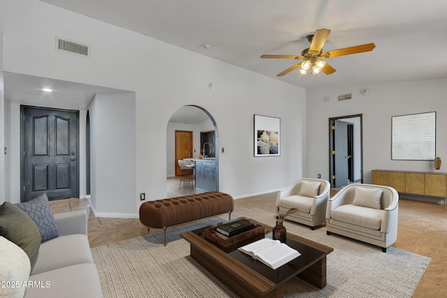 15210 S Country Club Way, Arizona City, AZ 85123 - living room featuring visible vents, arched walkways, ceiling fan, and vaulted ceiling
