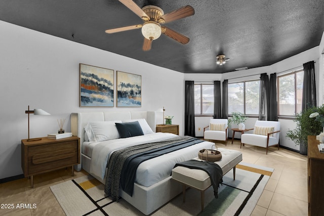 15210 S Country Club Way, Arizona City, AZ 85123 - bedroom with light tile patterned floors, baseboards, and a textured ceiling