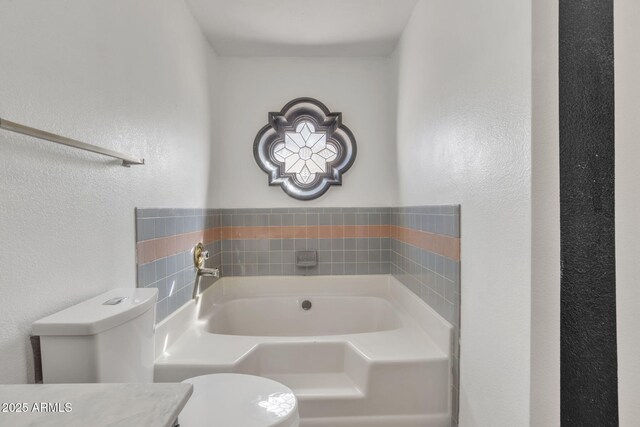 15210 S Country Club Way, Arizona City, AZ 85123 - full bathroom with toilet, a garden tub, and a textured wall