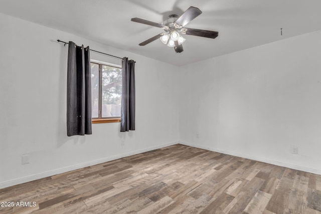 15210 S Country Club Way, Arizona City, AZ 85123 - spare room featuring baseboards, ceiling fan, and wood finished floors