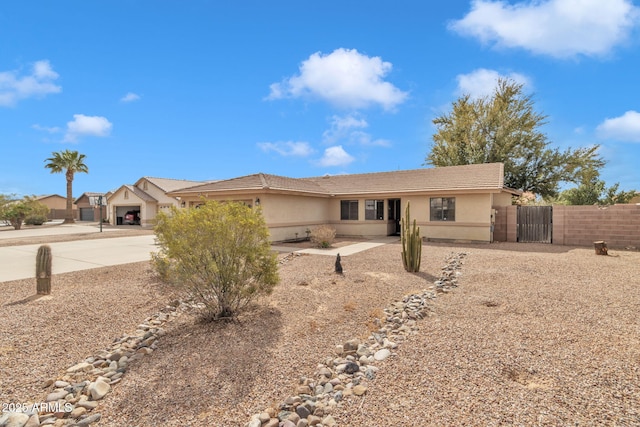 15210 S Country Club Way, Arizona City, AZ 85123 - ranch-style house featuring fence, concrete driveway, stucco siding, an attached garage, and a gate