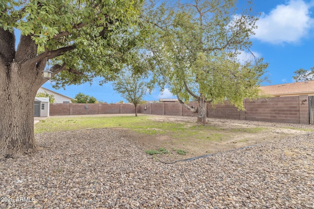 15210 S Country Club Way, Arizona City, AZ 85123 - view of yard with an outdoor structure, a fenced backyard, and a storage shed