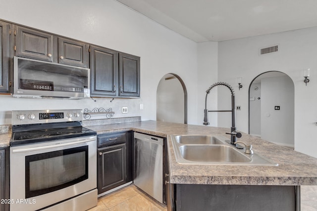 15210 S Country Club Way, Arizona City, AZ 85123 - kitchen featuring a sink, visible vents, arched walkways, and appliances with stainless steel finishes