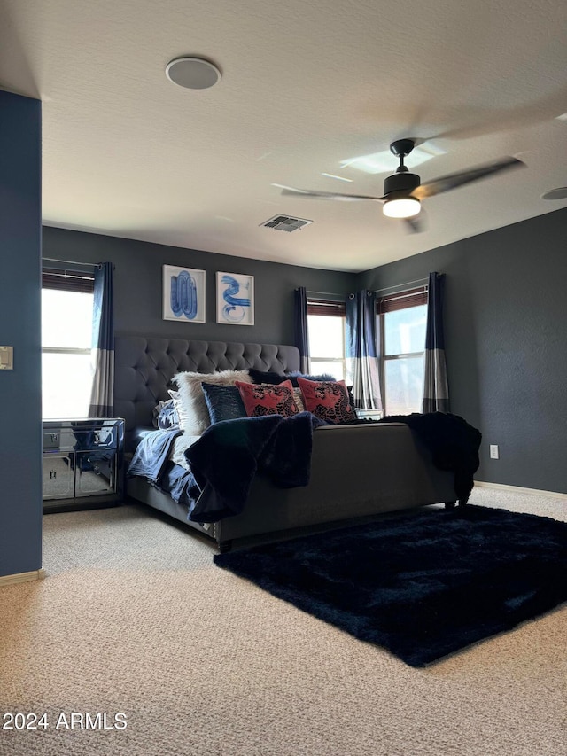 bedroom featuring carpet floors, multiple windows, and ceiling fan