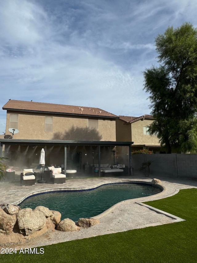 view of pool featuring outdoor lounge area, a lawn, and a patio