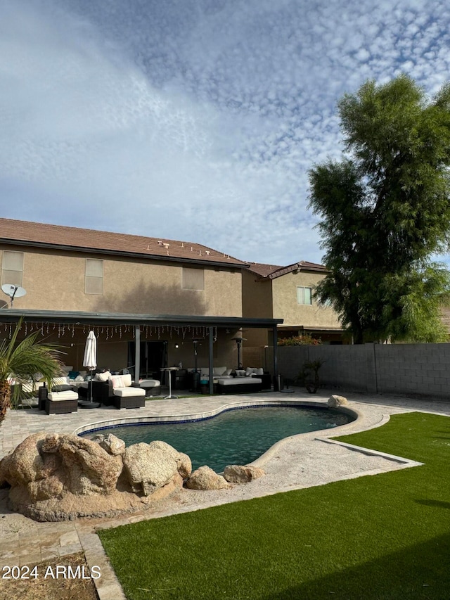 view of pool featuring an outdoor living space, a lawn, and a patio