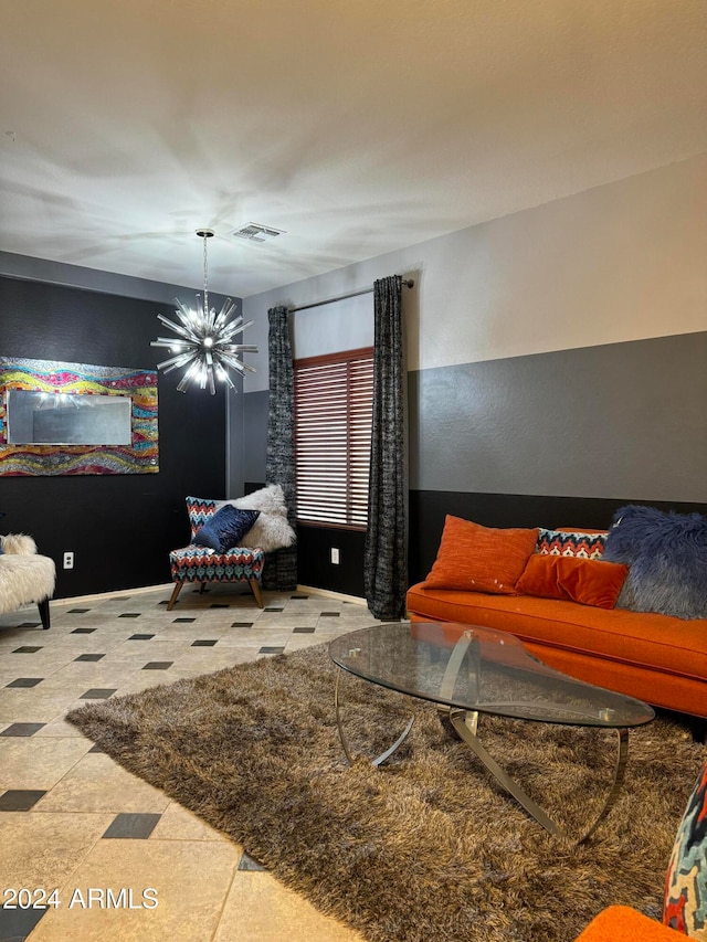 living room with tile patterned flooring and a notable chandelier