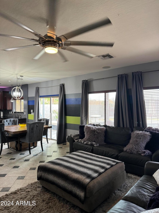 living room with ceiling fan and a healthy amount of sunlight