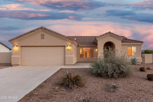 8271 W Cypress Point Cir, Arizona City, AZ 85123 - mediterranean / spanish house with driveway, stucco siding, an attached garage, and a tile roof
