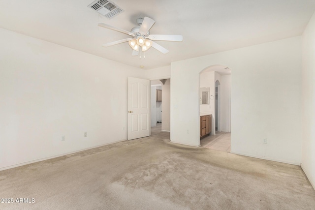 8271 W Cypress Point Cir, Arizona City, AZ 85123 - unfurnished room featuring arched walkways, light carpet, and a ceiling fan
