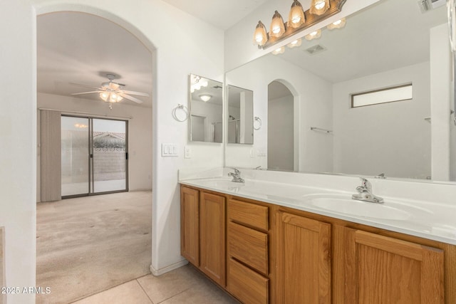 8271 W Cypress Point Cir, Arizona City, AZ 85123 - full bath with double vanity, a ceiling fan, and tile patterned flooring
