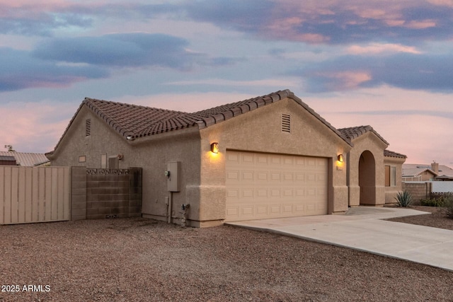 8271 W Cypress Point Cir, Arizona City, AZ 85123 - mediterranean / spanish-style home featuring driveway, an attached garage, stucco siding, and a tiled roof