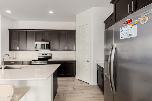 3842 E Bartlett Way, Chandler, AZ 85249 - kitchen featuring stainless steel appliances, a sink, recessed lighting, light countertops, and dark brown cabinetry