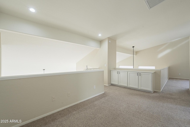 unfurnished room with light carpet and vaulted ceiling