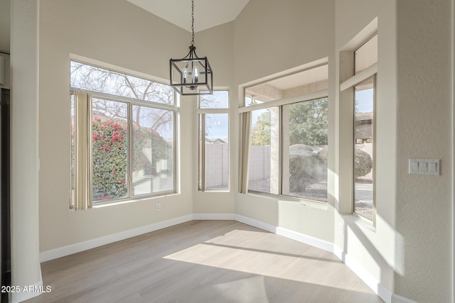 unfurnished sunroom featuring a notable chandelier