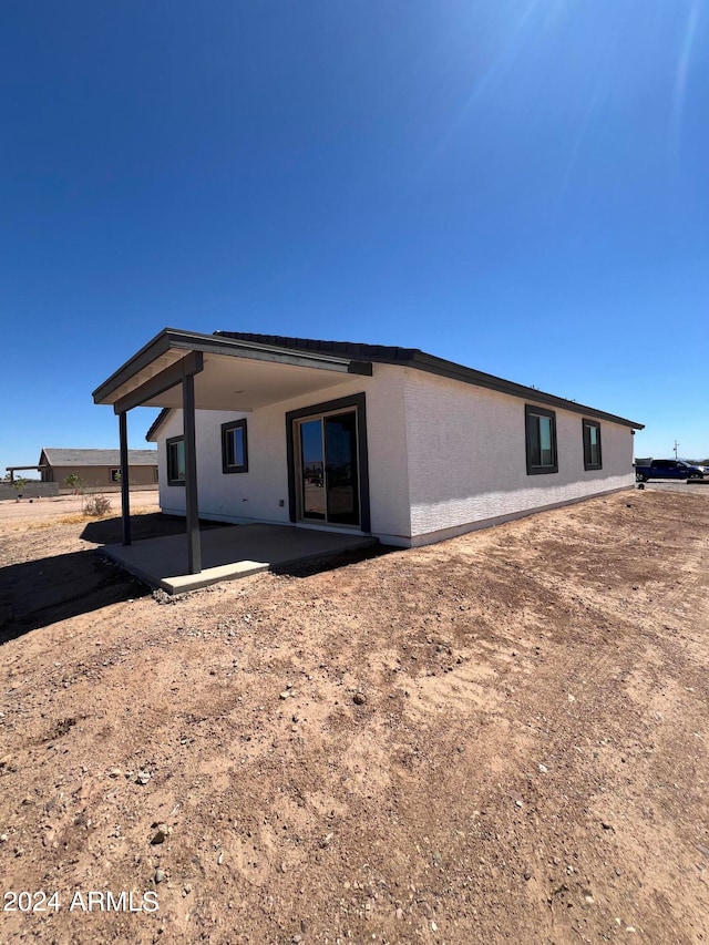 back of property with a patio area